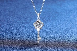 Macro detail of S925 sterling silver key necklace with brilliant moissanite crown pendant