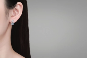 Close-up of S925 sterling silver moissanite stud earring with infinity tassel design