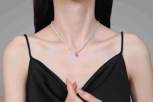 Close-up of S925 sterling silver necklace with a brilliant blue round moissanite pendant