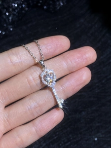 Detail of s925 silver key pendant necklace set with brilliant moissanite stones