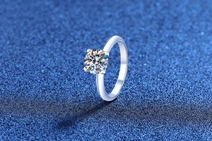 Macro view of classic round brilliant-cut moissanite set in a 4-prong silver ring
