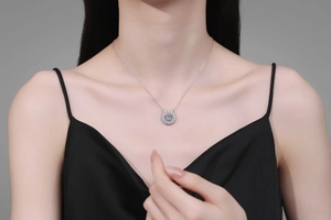 Close-up of S925 silver horseshoe necklace with Moissanite stone worn on female model