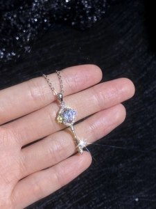 Close-up of sparkling moissanite key pendant necklace with a detailed diamond halo