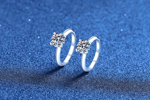 Macro detail of classic four-prong silver rings with brilliant round-cut moissanite stones