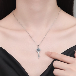 S925 sterling silver crown key pendant necklace with sparkling moissanite on a model