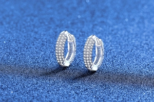 Detailed close-up of S925 sterling silver hoop earrings with full pave moissanite settings