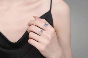 Detailed view of two S925 sterling silver rings with classic round moissanite in six-prong setting