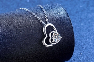 Macro shot of double heart pendant necklace with sparkling moissanite stone