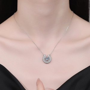S925 sterling silver horseshoe necklace with moissanite pendant worn by a model