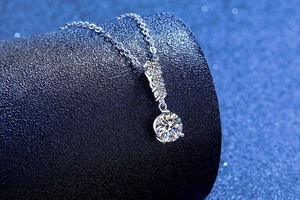 Detailed macro view of S925 silver necklace with brilliant round moissanite pendant