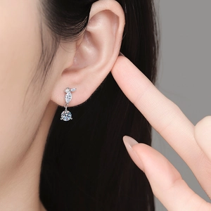 Elegant moissanite drop earrings with tassel leaf design on model in silver finish