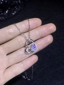 Detail of S925 sterling silver double heart pendant featuring a brilliant moissanite stone