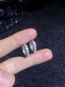 Detailed view of S925 silver hoop earrings with shimmering pave-set moissanite stones