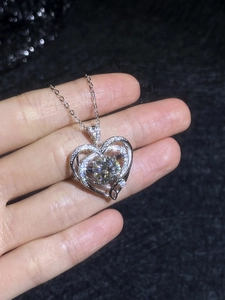 Close-up of sparkling 3-carat moissanite heart pendant on a 925 sterling silver chain