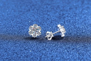 Close-up of S925 sterling silver snowflake stud earrings with moissanite stones