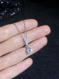 Close-up of S925 sterling silver moissanite pendant with brilliant round-cut stone