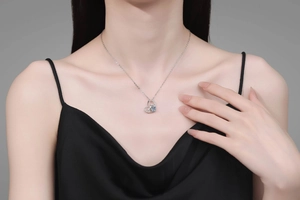Close-up of a sterling silver heart pendant necklace with a large round-cut moissanite