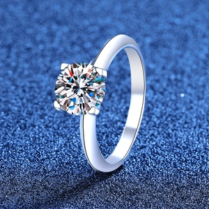 Classic S925 sterling silver four-prong moissanite engagement ring on dark background