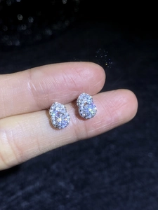 Macro shot of silver gourd stud earrings with brilliant moissanite pavé crystals
