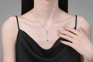 Close-up of S925 sterling silver Y-shaped necklace with pearl and zircon on model