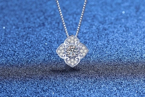 Macro shot of S925 silver moissanite necklace with square floral pendant and box chain