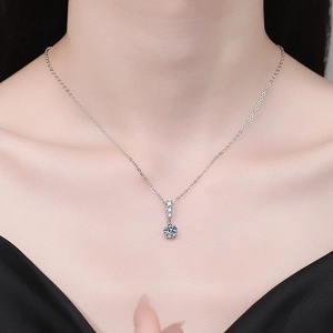 Elegant S925 sterling silver moissanite necklace worn by a model on a black background