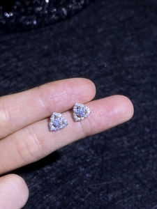 Macro view of sterling silver flower stud earrings with shimmering moissanite stones