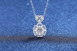 Detailed view of silver heart and snowflake pendant with moissanite stones and fine chain