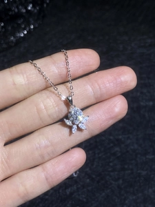 Macro view of S925 sterling silver flower necklace with sparkling moissanite petals