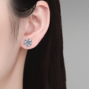 Elegant S925 sterling silver snowflake moissanite stud earrings worn by a model