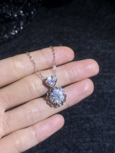 Macro shot of S925 silver heart and snowflake moissanite pendant with sparkling stones