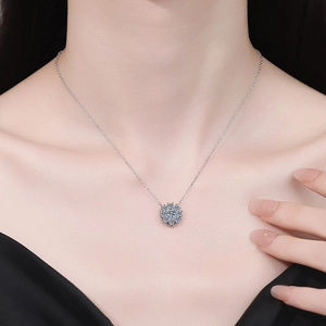 Elegant s925 silver snowflake pendant necklace with blue moissanite on a female model
