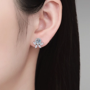 Sparkling Moissanite flower stud earrings in S925 sterling silver worn by a model