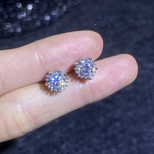Sparkling S925 sterling silver moissanite sunflower stud earrings on fingertips