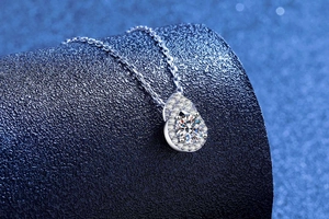 Vue macro d'un pendentif en moissanite en forme de poire avec un halo de diamants