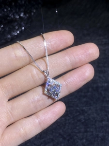 Macro shot of S925 silver necklace featuring a geometric square moissanite pendant