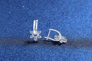 Detailed macro view of S925 sterling silver snowflake earrings with moissanite diamonds