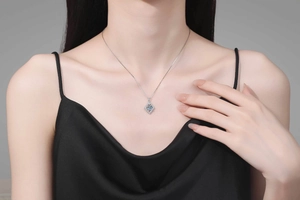 Close-up of S925 sterling silver necklace with a square moissanite pendant on a model