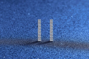 Macro detail of vertical row moissanite studs on S925 sterling silver earrings