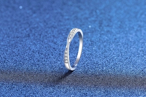 Macro detail of S925 sterling silver moissanite ring with intertwined crystal band