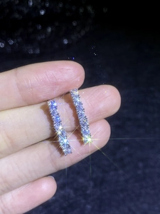 Macro detail of S925 sterling silver bar earrings with sparkling micro-pave moissanite