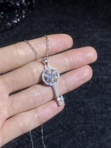 Detail of S925 silver kaleidoscope key pendant with sparkling moissanite on fine chain