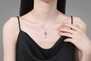 Close-up of S925 silver key pendant necklace with moissanite on a model neck