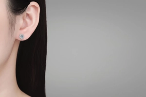 Macro detail of S925 sterling silver flower stud earring with moissanite on model