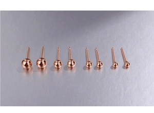 Macro detail of four sizes of rose gold S925 sterling silver ball stud earrings