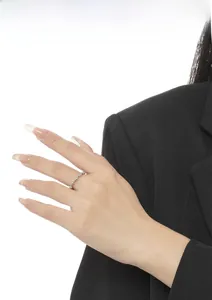 Close-up of minimalist silver beaded ring on model finger with black suit cuff