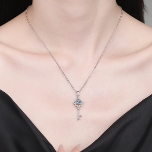 Exquisite silver key pendant necklace with moissanite stone worn by a model