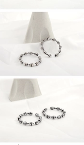 Detail view of S925 sterling silver braided ring with vintage oxidized finish and bead texture