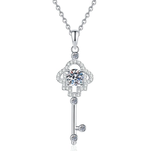 Sparkling silver key pendant necklace with a brilliant round moissanite and openwork design