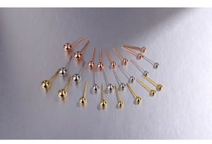 Macro shot of 925 sterling silver ball earrings in gold, rose gold and silver finishes